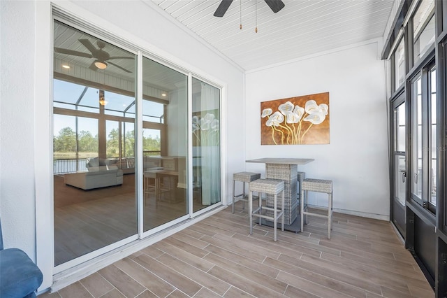 sunroom with ceiling fan and a healthy amount of sunlight