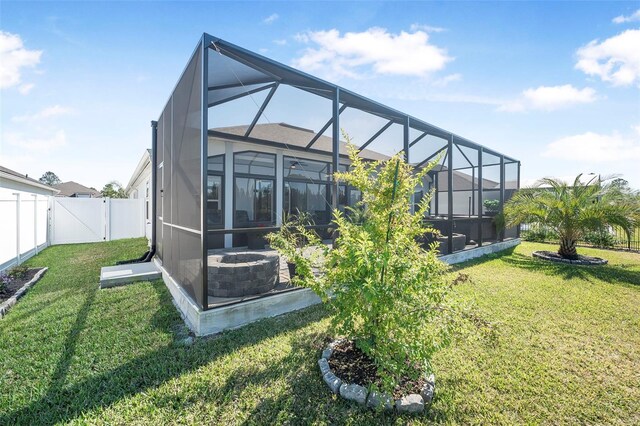 rear view of property with a yard and a lanai