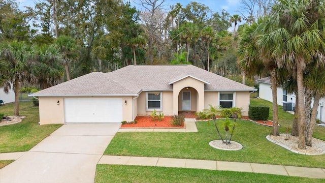 ranch-style home featuring a garage, central AC unit, and a front lawn