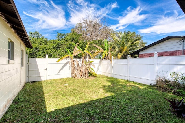 view of yard with a fenced backyard