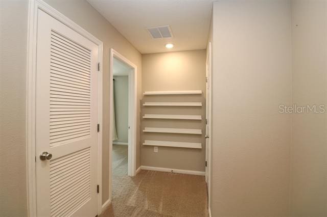 hallway featuring carpet flooring