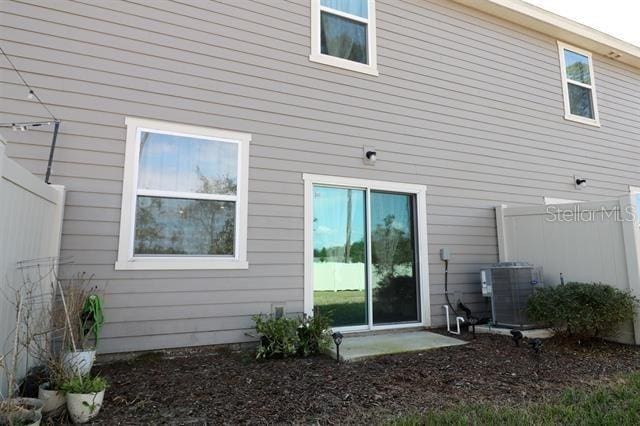 rear view of property featuring central AC