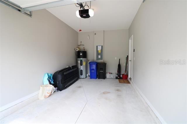 garage with water heater, a garage door opener, and electric panel