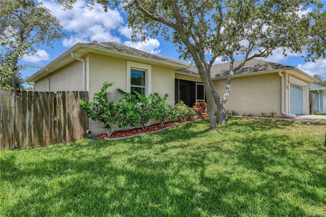 single story home featuring a garage and a front yard