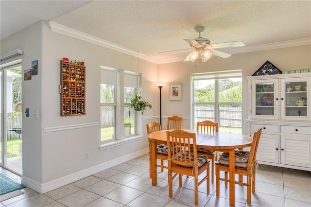 tiled dining area with crown molding, ceiling fan, and a textured ceiling