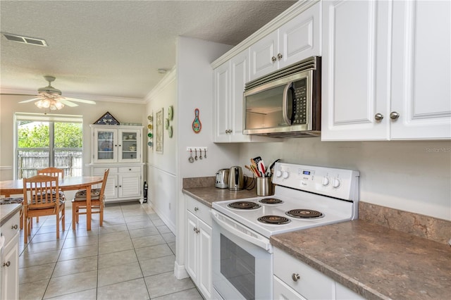 kitchen with white cabinetry, light tile patterned floors, ceiling fan, a textured ceiling, and electric stove