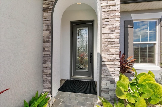 view of exterior entry with stone siding