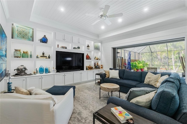 living room featuring built in features, a ceiling fan, wood ceiling, and crown molding