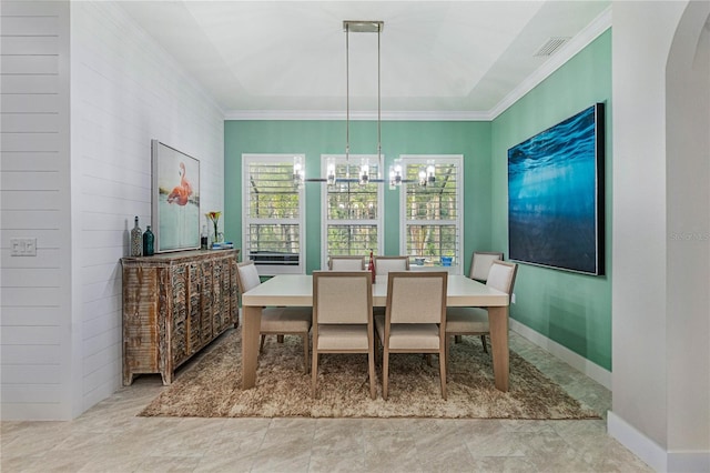 dining space with visible vents, arched walkways, crown molding, baseboards, and a chandelier