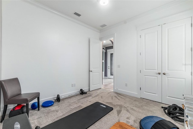 workout area featuring visible vents, crown molding, baseboards, and carpet floors