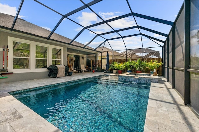 view of swimming pool with a lanai, a grill, a pool with connected hot tub, and a patio