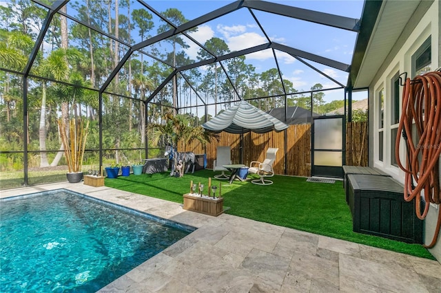 pool featuring a patio area, a lanai, and a yard