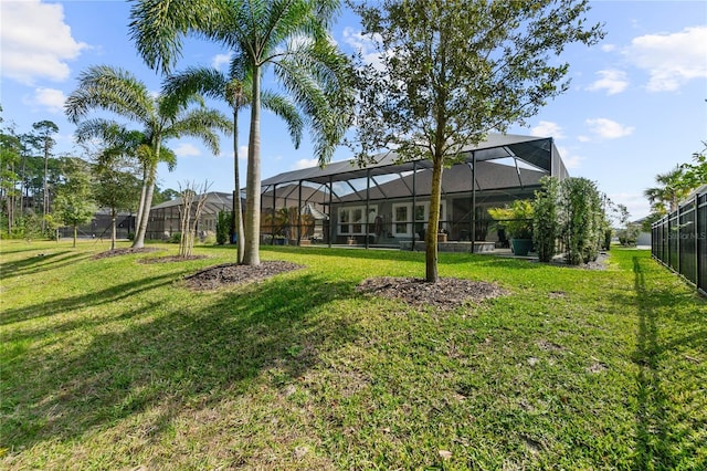 view of yard featuring a lanai and fence