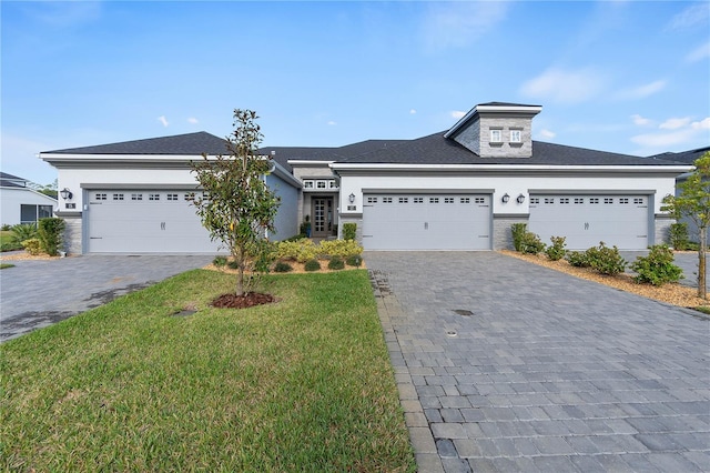 view of front of house with a garage and a front yard