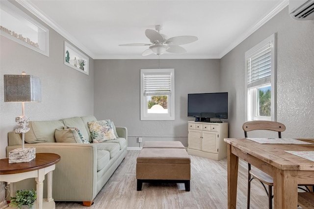 living room with ornamental molding, an AC wall unit, ceiling fan, and light wood-type flooring