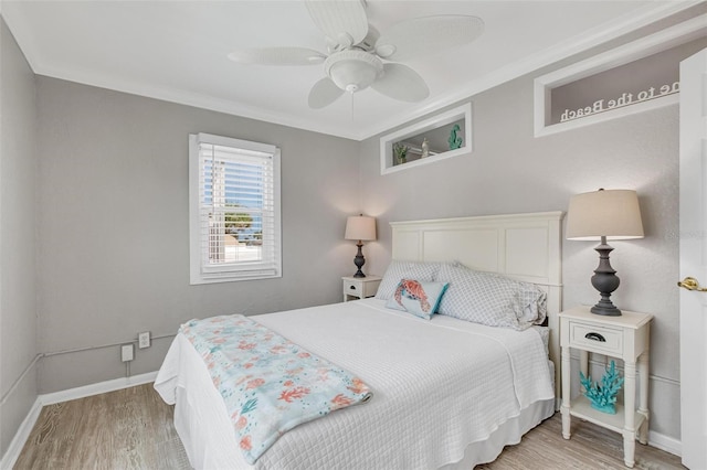 bedroom featuring crown molding, ceiling fan, and light hardwood / wood-style floors