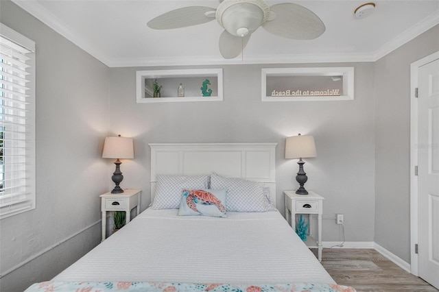 bedroom with ceiling fan, ornamental molding, and light hardwood / wood-style floors