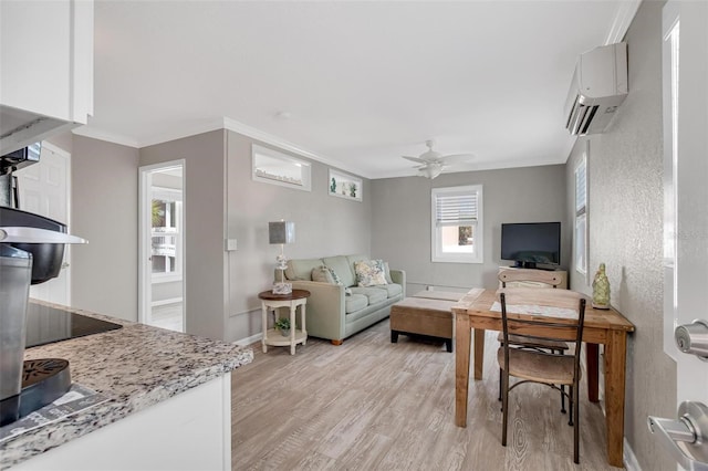 living room with crown molding, ceiling fan, light hardwood / wood-style flooring, and an AC wall unit