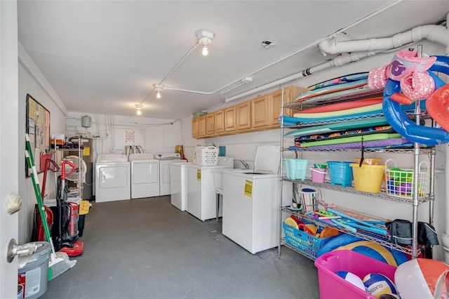 laundry room featuring separate washer and dryer and water heater