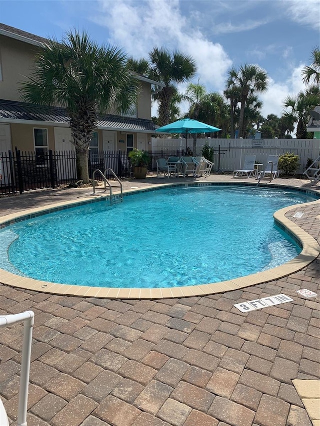 view of swimming pool with a patio area