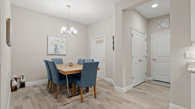 dining space with a chandelier and light hardwood / wood-style floors