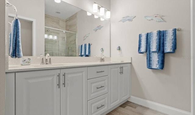 bathroom featuring vanity, hardwood / wood-style flooring, and walk in shower