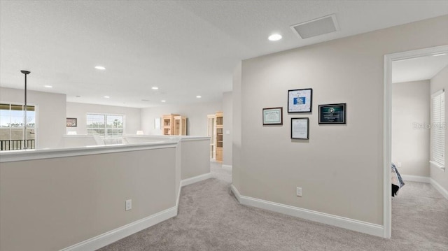 corridor with light colored carpet