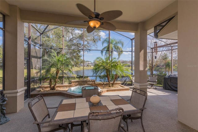 view of patio / terrace with ceiling fan, a grill, glass enclosure, and a water view