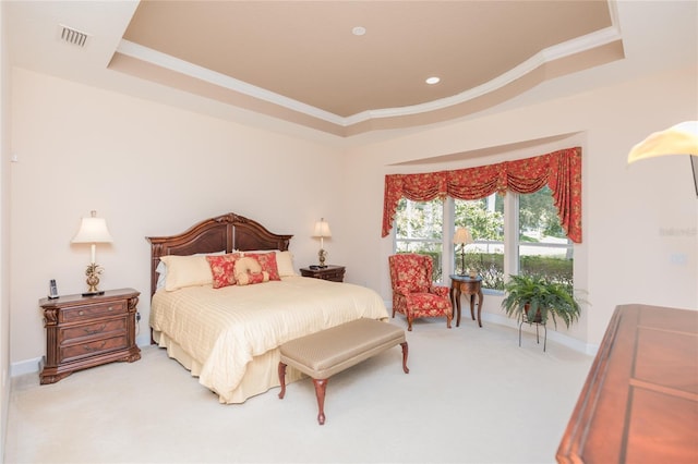 carpeted bedroom featuring a raised ceiling and ornamental molding