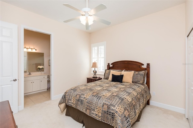 carpeted bedroom with ceiling fan and ensuite bathroom