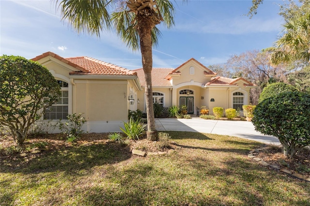 mediterranean / spanish house with a front yard