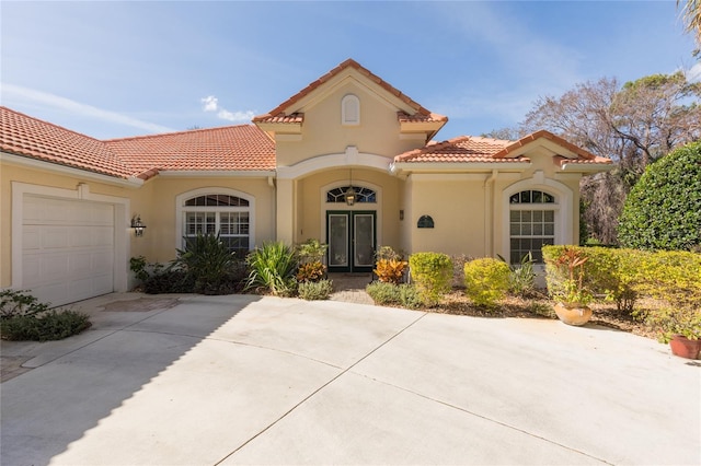 mediterranean / spanish-style home with a garage