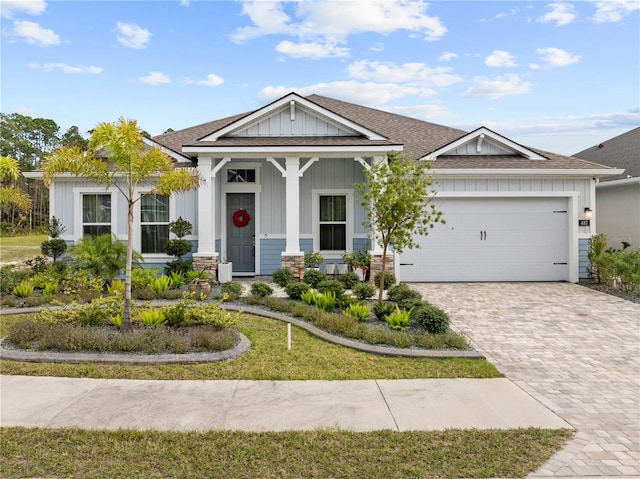 view of front of house featuring a garage and a front lawn