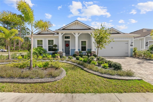 view of front of home featuring a garage and a front lawn