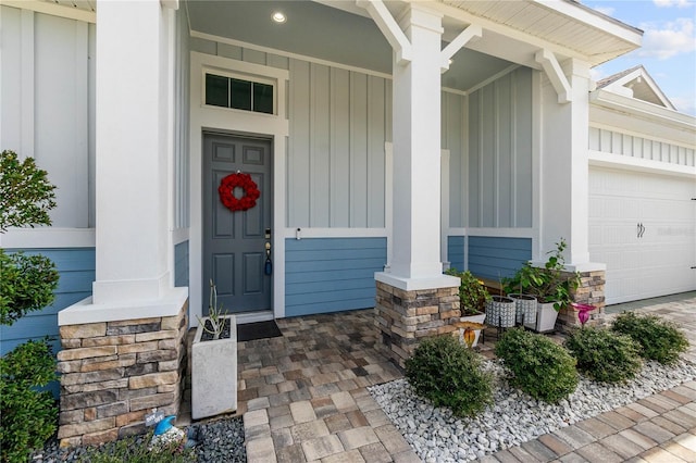 entrance to property featuring a garage and covered porch