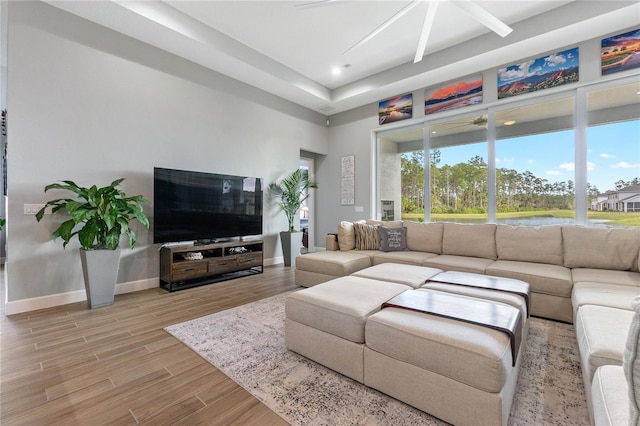 living room featuring ceiling fan and light wood-type flooring