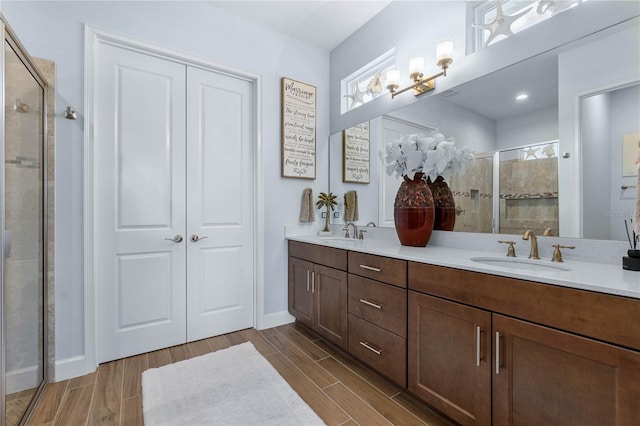 bathroom with vanity and a shower with shower door