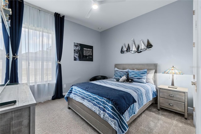 bedroom with light carpet and ceiling fan