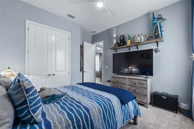 carpeted bedroom with a closet and ceiling fan