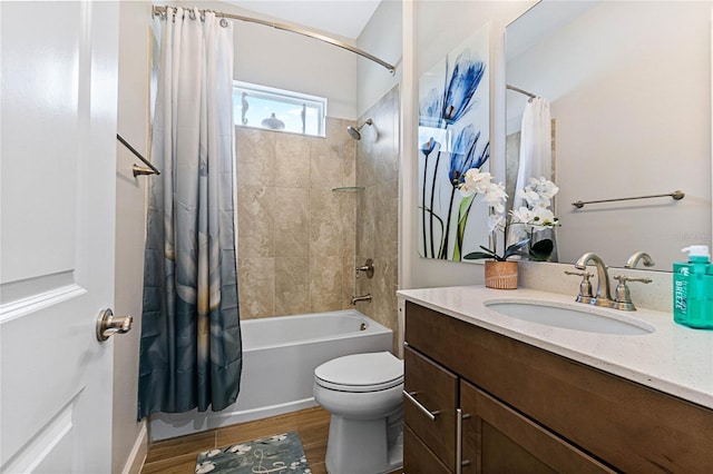 full bathroom with vanity, hardwood / wood-style floors, toilet, and shower / bath combo with shower curtain