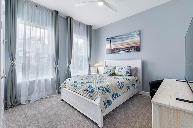 bedroom featuring ceiling fan and carpet