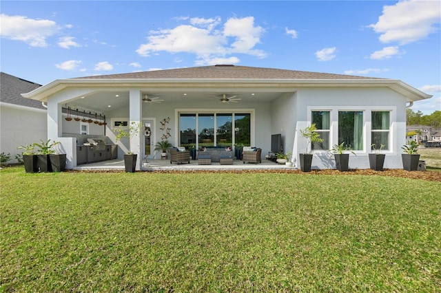 rear view of house with a patio area, area for grilling, a lawn, outdoor lounge area, and ceiling fan