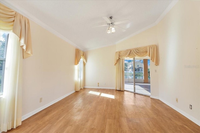 spare room with crown molding, vaulted ceiling, ceiling fan, and light hardwood / wood-style floors