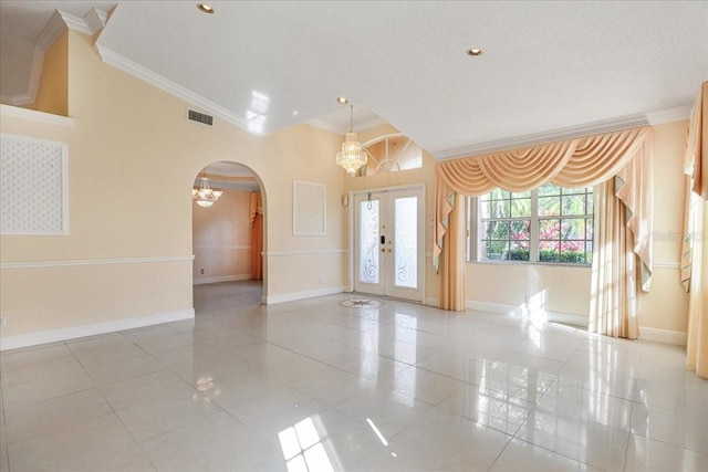 unfurnished room featuring a notable chandelier, crown molding, a textured ceiling, and light tile patterned flooring