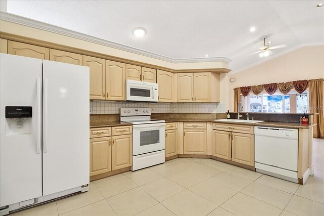 kitchen featuring sink, light brown cabinetry, white appliances, and decorative backsplash