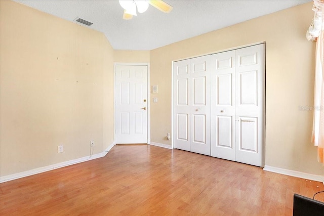 unfurnished bedroom with ceiling fan, light hardwood / wood-style floors, and a closet