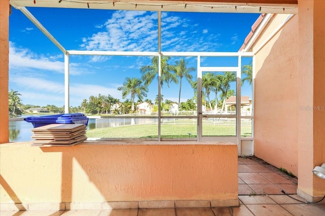 unfurnished sunroom with a water view