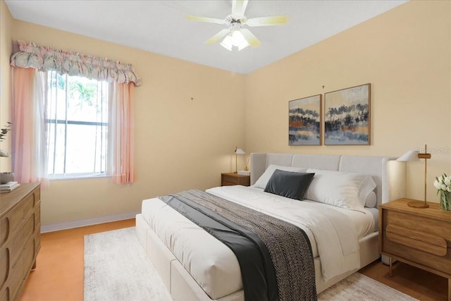 bedroom with ceiling fan and light carpet