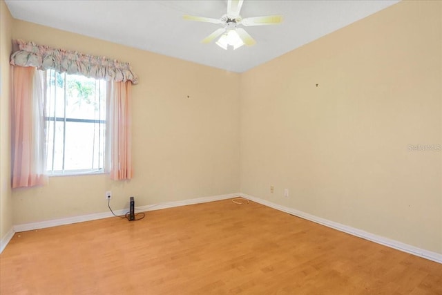 empty room with hardwood / wood-style floors and ceiling fan