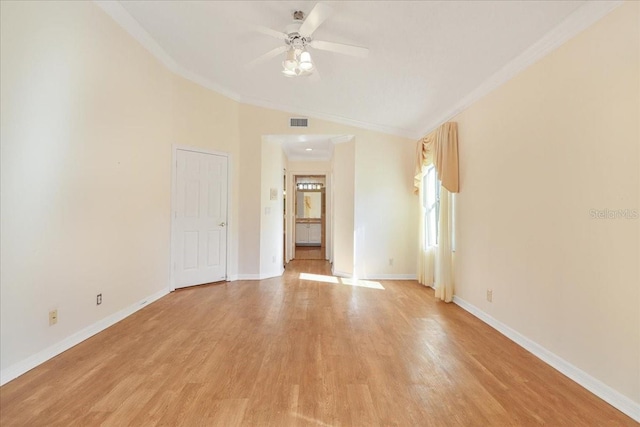 unfurnished room with vaulted ceiling, crown molding, ceiling fan, and light wood-type flooring